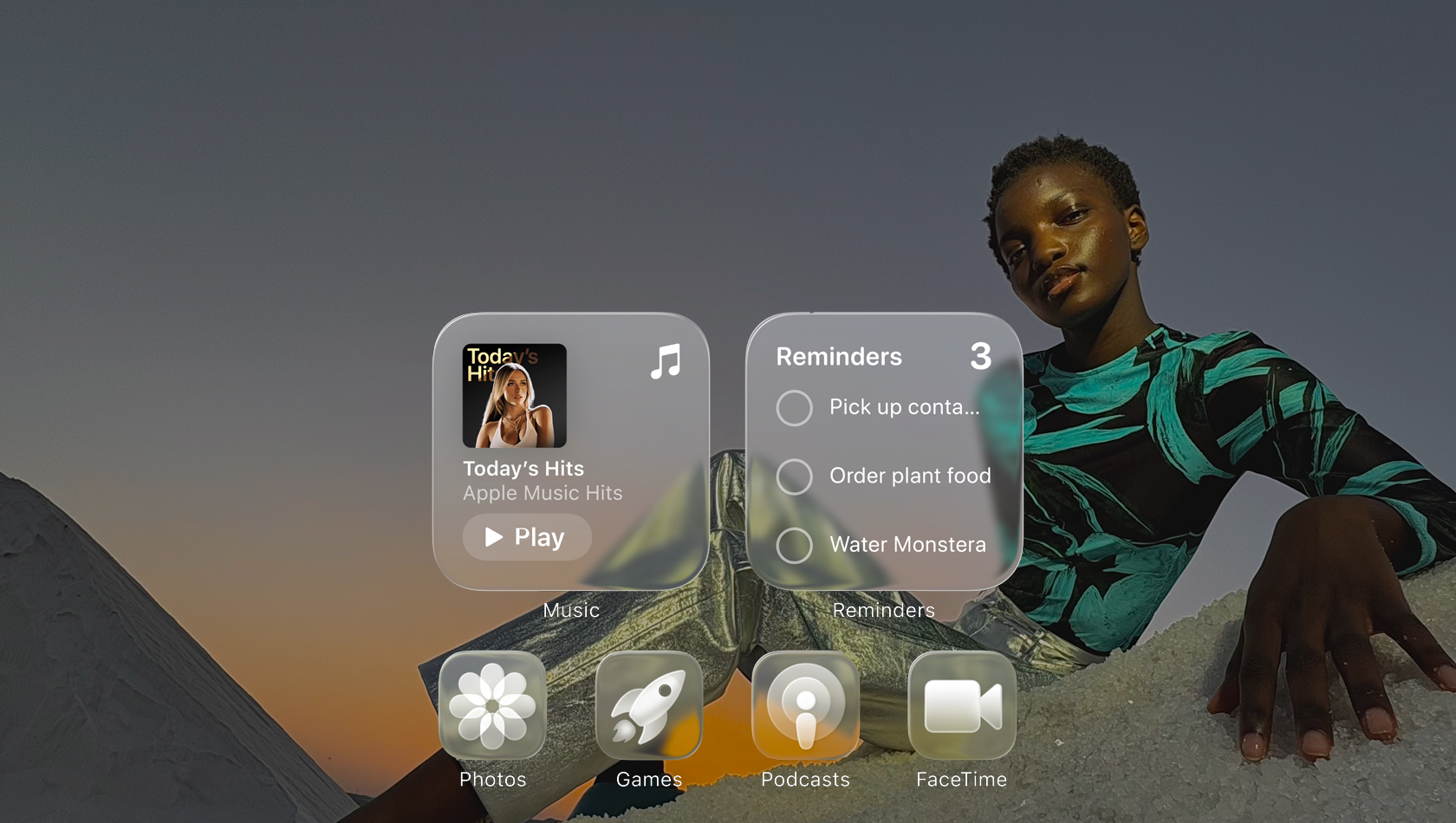 Liquid Glass display with clear app icons, like Apple Music, Reminders, Photos, Games, Podcasts and FaceTime refracting against the wallpaper